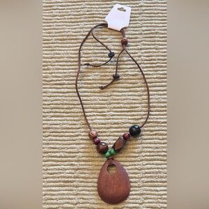 New bohemian-style necklace features a large, brown, teardrop-wooden pendant